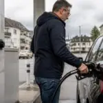 Οδηγός ανεφοδιάζει αυτοκίνητο με καύσιμα σε πρατήριο στην Ελβετία.
