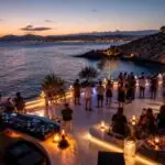 Symbolbild einer beleuchteten Clubterrasse an der Athener Riviera mit Blick auf das Meer