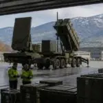 Αντιαεροπορικός εξοπλισμός Patriot σε χώρο στρατιωτικής εφοδιαστικής με αλπικό φόντο, συμβολική εικόνα για την προμήθεια της Ελβετίας