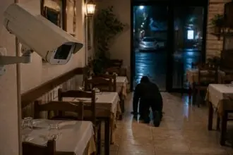 Symbolbild: Überwachungskamera in einem Restaurant und eine nicht erkennbare Person am Boden